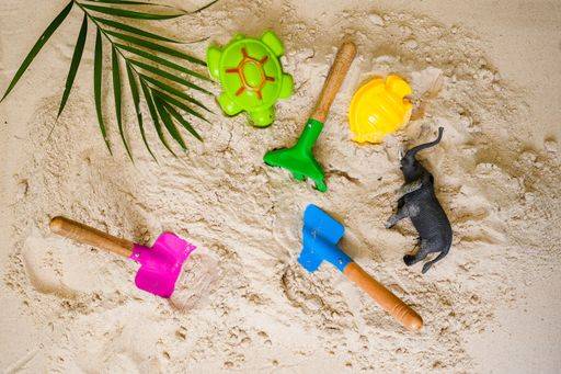 RECORD DATE NOT STATED A flat lay of colorful sand toys including shovels and animals on the sand *** einer flach legen des farbenfroh sandigen Spielzeug einschließlich Schaufeln und Tiere am der sandigen 7211318