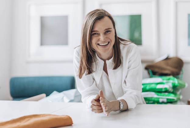 Happy fashion designer leaning on workbench model released, Symbolfoto property released, ADF00025
