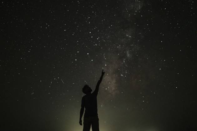 Silhouette of young man pointing towards stars model released, Symbolfoto, GMLF01456
