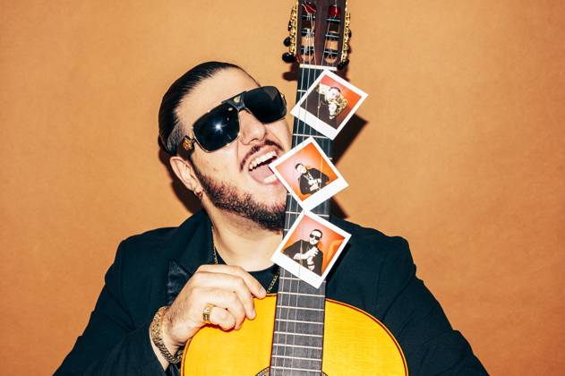 MR_ID13306_13123_JuanCarrasco.jpg, PR_ID13306_3354_FotosIstax.jpg Portrait of bearded male hipster in black jacket and sunglasses looking at camera while standing against orange background with acoustic guitar with photos in studio, Model released, Property released JoseLuisCarrascosa_ID13306_405803_034 Copyright: xJosexLuisxCarrascosax MR