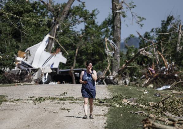 July 1, 2023, Carstairs, AB, CANADA: A woman looks for her belongings after a tornado damaged homes near Carstairs, Alta., Saturday, July 1, 2023. No injuries were reported. Carstairs CANADA  - ZUMAc35_ 20230701_zaf_c35_134 Copyright: xJeffxMcintoshx