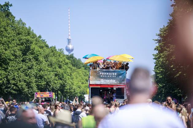 Rave the Planet 2023 Germany, Berlin on 08 July 2023 about 200 000 ravers and techno fans parade through the Tiergarten on the Starsse des 17 Juni on a hot summer day A young woman holds up a homemade sign that reads Love is the Answer