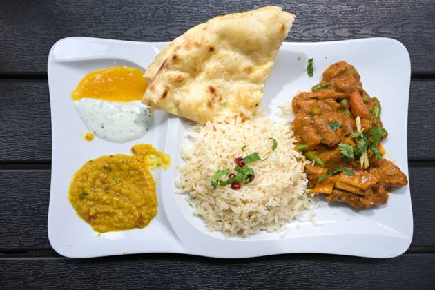 IMAGO Creative, Food, Brot, Naan Indian meat dish of beef with sauce, rice, bread, lentils and dips, served on a white plate and a dark table, high angle view from above, selected focus Indian meat dish of beef with sauce, rice, bread, lentils and dips, served on a white plate and a dark table, high angle view from above, selected focus Copyright: xZoonar.com MarenxWinterx 20444874