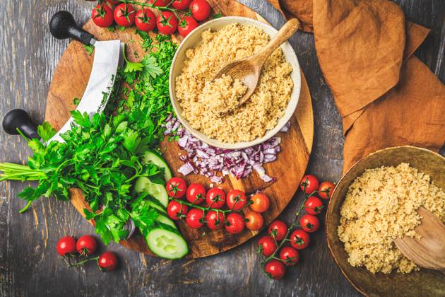 Preparing traditional oriental salad Tabouleh with couscous or bulgur Preparing traditional oriental salad Tabouleh with couscous or bulgur, ingredients on cutting board Copyright: xZoonar.com IngridxBalabanovax 20448956