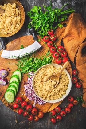 Preparing traditional oriental salad Tabouleh with couscous or bulgur Preparing traditional oriental salad Tabouleh with couscous or bulgur, ingredients on cutting board Copyright: xZoonar.com IngridxBalabanovax 20448960