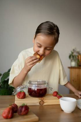 IMAGO Creative, Jahreszeit Sommer, Food, Marmelade kochen PR_ID15648_4255_Room.jpg, MR_ID15648_14435_VarvaraSolopova.jpg Portrait of dreamy girl in casual clothes eating delicious pancake with homemade strawberry jam while standing at table in bright room, Property released MR LiliyaSolopova_ID15648_475546_031 Copyright: xLiliyaxSolopovax Model Released