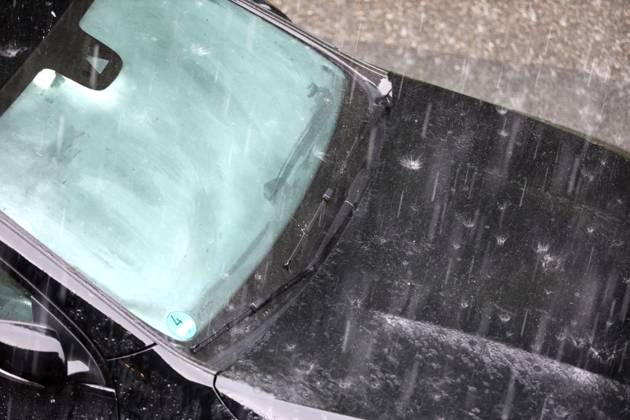 Dangerous road conditions during heavy rain Heavy rain pelts a car and the suddenly fogged window takes away all visibility