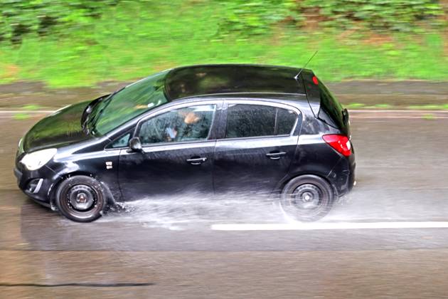 Dangerous road conditions during heavy rains Cars driving through sudden heavy rains and poor visibility