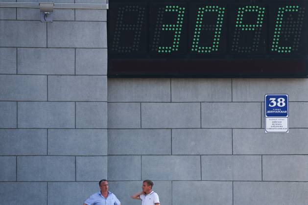 RUSSIA, NOVOSIBIRSK - AUGUST 24, 2023: Men are seen outside the city hall. Kirill Kukhmar TASS 61281225