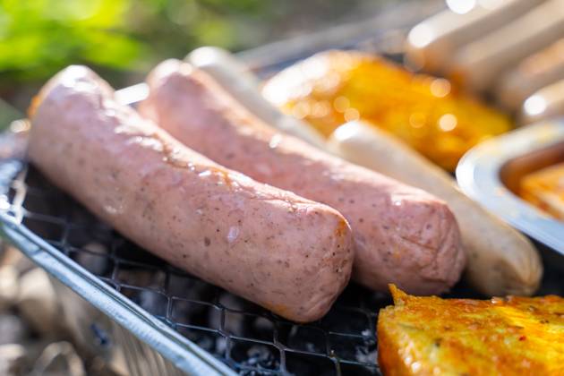 Bavaria, Germany - 2 September 2023: Vegetarian Grilling, Bratwurst Vegan and Vegetarian on a disposable grill. Meat and sausage substitutes