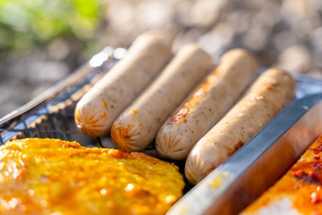 Bavaria, Germany - 2 September 2023: Vegetarian Grilling, Bratwurst Vegan and Vegetarian on a disposable grill. Meat and sausage substitutes