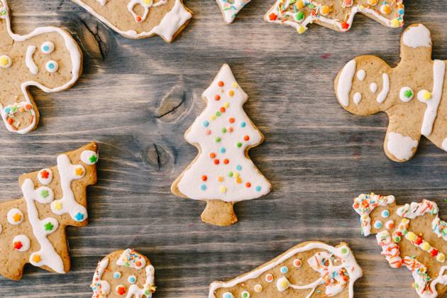 Close-up of Christmas gingerbread cookies on a wood texture. Fir-trees, little men and bells decorated with white glaze with multi-colored dots. Close-up of Christmas gingerbread cookies on a wood texture. Fir-trees, little men and bells decorated with white glaze with multi-colored dots. High quality photo Copyright: xZoonar.com NadtochiixVolodymyrx 17740063