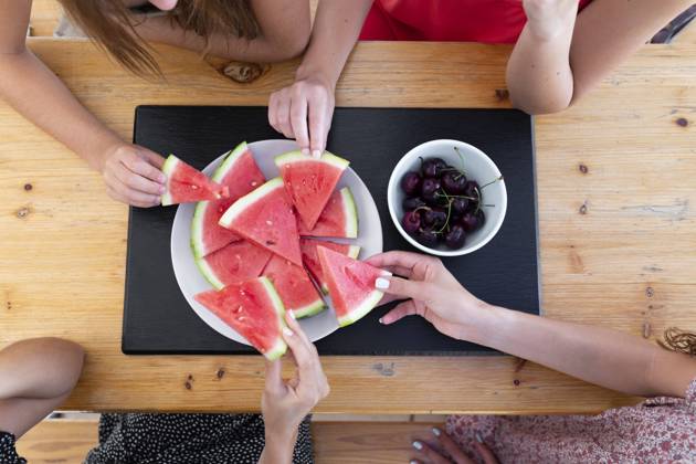 Friends having watermelon and cherries at table model released, Symbolfoto property released, JPTF01287