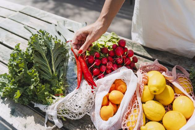 Woman holding red chilies and buying fresh vegetables in market model released, Symbolfoto, NDEF01000