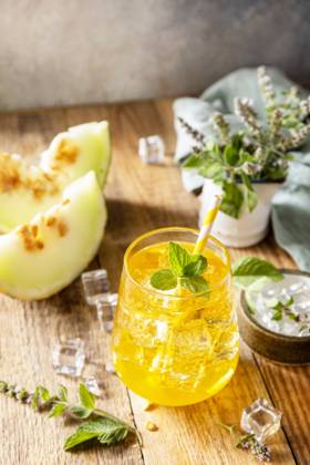 Fresh refreshing fruity summer drink, seasonal beverages. Melon lemonade in glasses with ice and mint on a wooden rustic table. Fresh refreshing fruity summer drink, seasonal beverages. Melon lemonade in glasses with ice and mint on a wooden rustic table. Copyright: xZoonar.com ELENAxHRAMOVAx 20552303