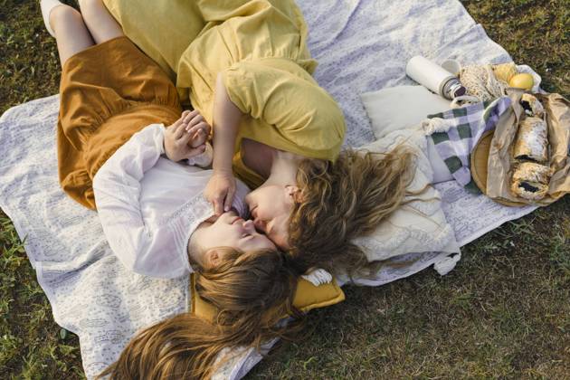 Mother and daughter rubbing noses and lying on picnic blanket model released, Symbolfoto, VBUF00400