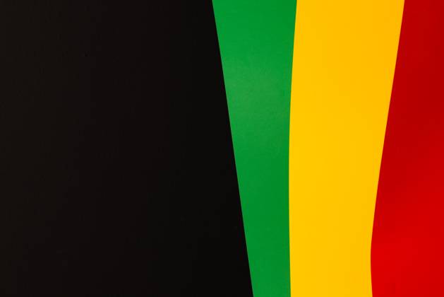 Green, yellow and red papers with copy space on black background. Black history month, africa, black culture and history concept.