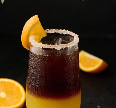 Iced coffee with orange juice in a transparent glass, refreshing bumble coffee on the table, black background Iced coffee with orange juice in a transparent glass, refreshing bumble coffee on the table, black background Copyright: xZoonar.com DANKOxNx 20465003