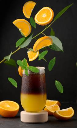 Iced coffee with orange juice in a transparent glass, refreshing bumble coffee on the table Iced coffee with orange juice in a transparent glass, refreshing bumble coffee on the table. Levitating orange slices and mint leaves Copyright: xZoonar.com DANKOxNx 20465809