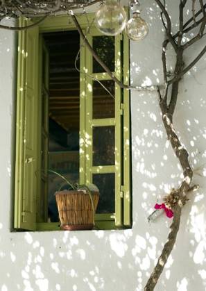 An old taverna white wall with a green window and a tree next to it in Folegandros, Greece 168110 RECORD DATE NOT STATED