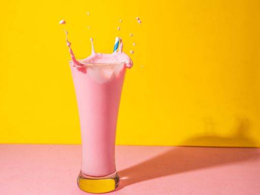 A glass of strawberry smoothie isolated on yellow and pink background 1043357 RECORD DATE NOT STATED