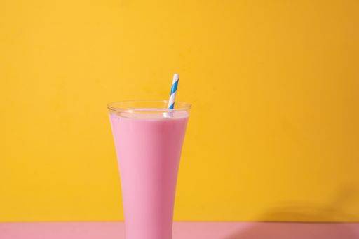 A glass of strawberry smoothie isolated on yellow and pink background 1043358 RECORD DATE NOT STATED