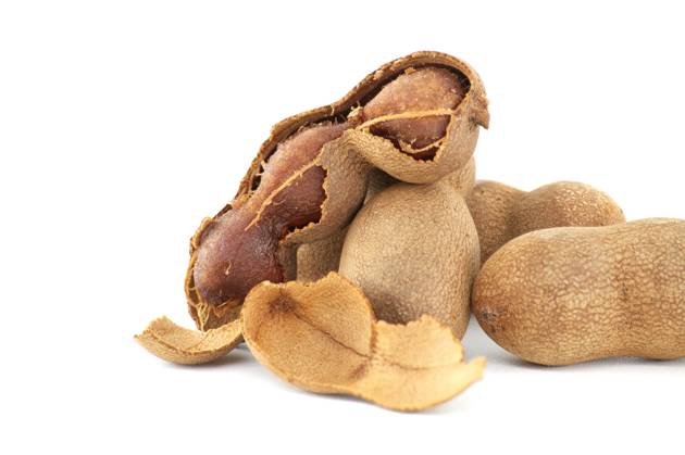 Tamarind whole and cracked open on white background Tamarind fruits, whole and cracked open isolated on white background (Tamarindus indica) Copyright: xZoonar.com NerijusxLiobex 20985885