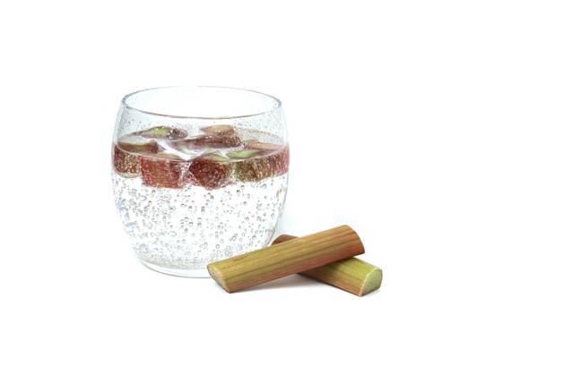 Glass of water with rhubarb pieces over white Transparent glass filled with cold water and several pieces of rhubarb isolated on white background Copyright: xZoonar.com NerijusxLiobex 21025456