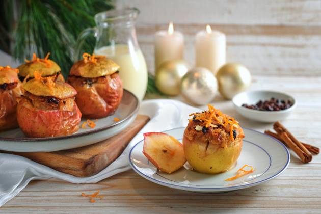Baked apples fresh from the oven with filling of almond, honey, and raisin, garnished with orange zest on a wooden table with Christmas decoration, festive holiday dessert, copy space Baked apples fresh from the oven with filling of almond, honey, and raisin, garnished with orange zest on a wooden table with Christmas decoration, festive holiday dessert, copy space, selected focus Copyright: xZoonar.com MarenxWinterx 21033154