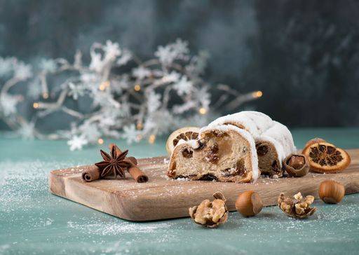 Christstollen, traditonal christmas cake with nuts, raisons, marzipan on a blue background, empty space for text 2773503 RECORD DATE NOT STATED