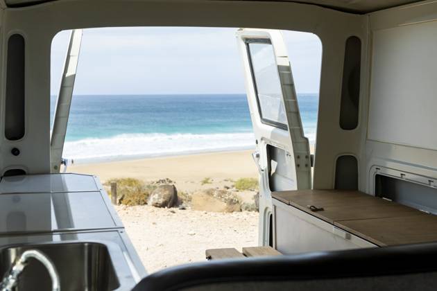 Experience tranquility through the open back of a vintage van overlooking a serene beach scene. Model Released JuanAizpuru_ID19709_584436_003 Copyright: xJuanxAizpurux