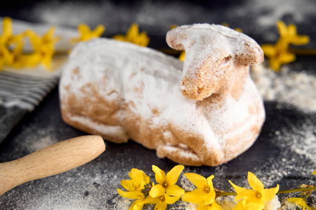 Augsburg, Bavaria, Germany - March 22, 2024: Traditional Easter lamb as a cake for Easter. Baking concept with flour, eggs and fresh yellow flowers