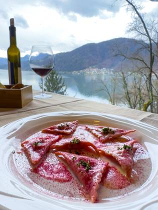 Restaurant table with red Pray Ravioli at a white Plate with Mountain view in the Switzerland Copyright: imageBROKER MatsxSilvan ibxvxo10353180.jpg