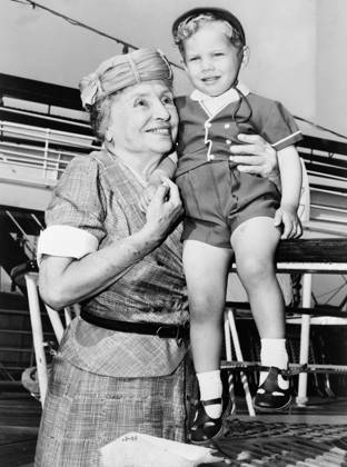 HELEN ADAMS KELLER (1880-1968). American writer and lecturer. Helen Keller with two-year-old Donald Hart on board the ocean liner Independence, after the ship docked in New York City. Photograph by Ed Ford, c1956.  Copyright: xGRANGERx xGRANGERx 0108295