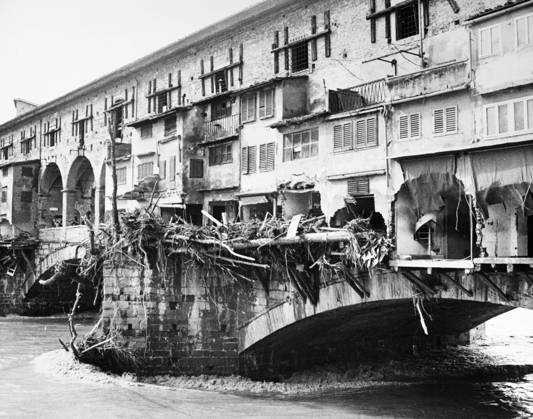 FLORENCE: FLOOD, 1966. Damage to goldsmith shops on the Ponte Vecchio and debris marking the high water line of the flood of the Arno River. Photograph, 5 November 1966.  Copyright: xGRANGERx xGRANGERx 0124011