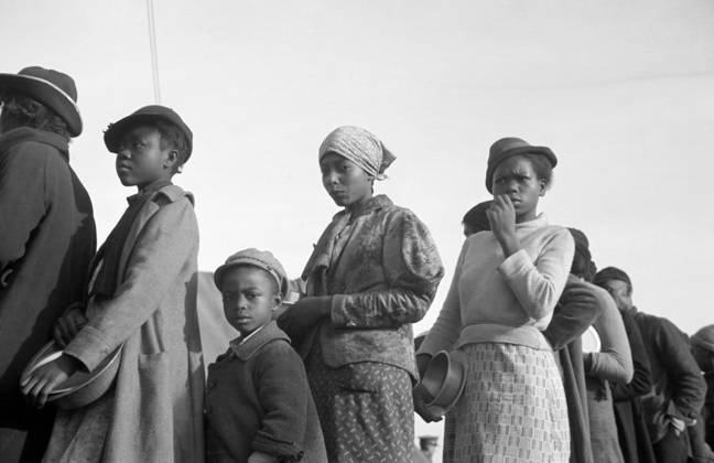 FLOOD REFUGEES, 1937. People waiting in a food line at a flood refugee camp in Forrest City, Arkansas. Photograph by Walker Evans, February 1937.  Copyright: xGRANGERx xGRANGERx 0323350