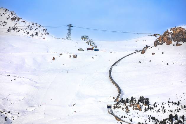 Town of Sankt Moritz luxury winter ski slope and cogwheel track view Town of Sankt Moritz luxury winter ski slope and cogwheel track view, Graubunden region of Switzerland Copyright: xZoonar.com DaliborxBrlekx 21263794