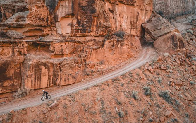 Creative Highlights Symbolbilder Man rides bike down narrow dirt road on cliff face, Moab, Utah Moab, Utah, United States CR_SSNF240416E-1380705-01 ,model released, Symbolfoto