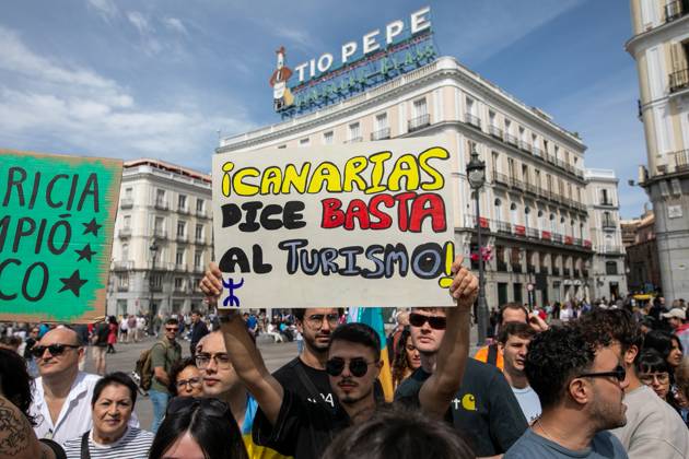 April 20, 2024, Madrid, Spain: A protester holds a placard with the slogan Canary Islands says enough to tourism during a rally in Madrid. Under the motto The Canary Islands have a limit , various mobilizations have been held inside and outside the Spanish archipelago in which the citizens of the islands have demanded a new, amd more sustainable tourism model. In Madrid, dozens of people have gathered at Puerta de Sol. Madrid Spain - ZUMAs197 20240420_aaa_s197_051 Copyright: xDavidxCanalesx
