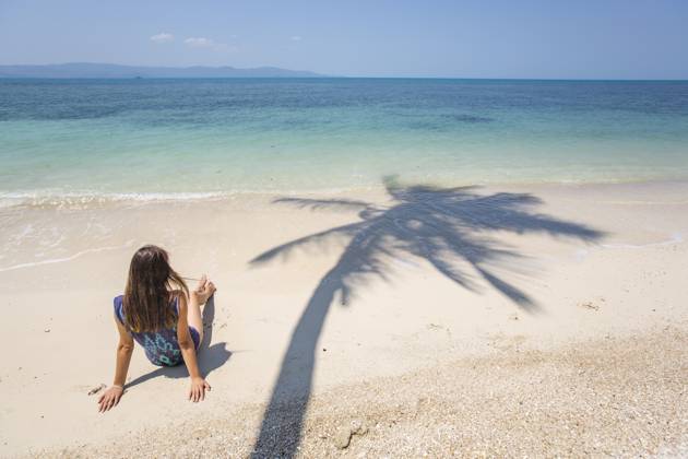 Woman resting on beach at sunny day model released, Symbolfoto, IKF01773