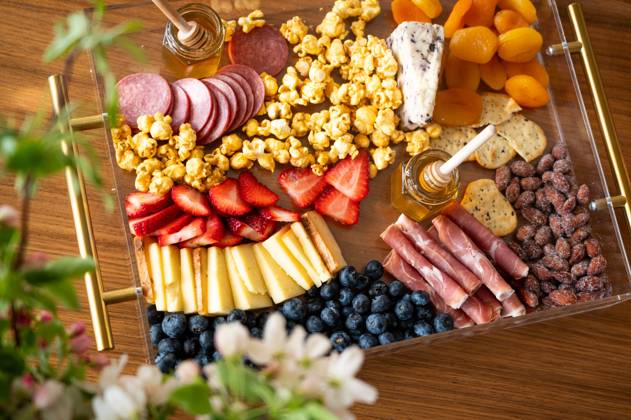 Charcuterie board adorned with cheeses, fruits, and cured meats. Syracuse, Utah, United States CR_WMWJ240502-1420250-01