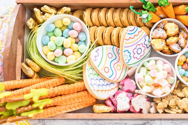 Easter charcuterie board Assembling charcuterie board with Easter candies, cookies, and marshmallows. Copyright: xArinaxHabich RECORD DATE NOT STATED