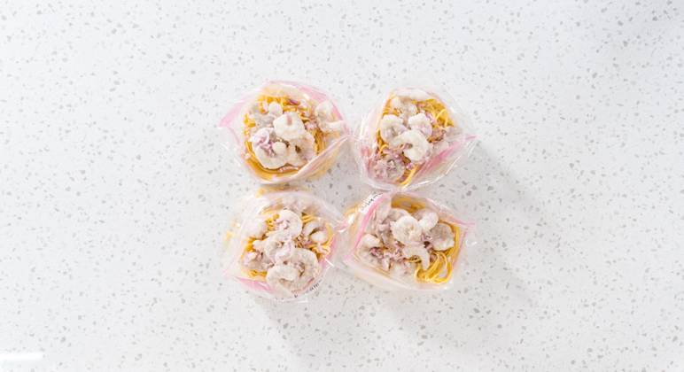 IMAGO Creative, Food, Trend, Meal Prep Frozen shrimp scampi meal prep Flat lay. Packaging homemade frozen shrimp scampi meal prep into plastic resealable bags. Copyright: xArinaxHabich RECORD DATE NOT STATED