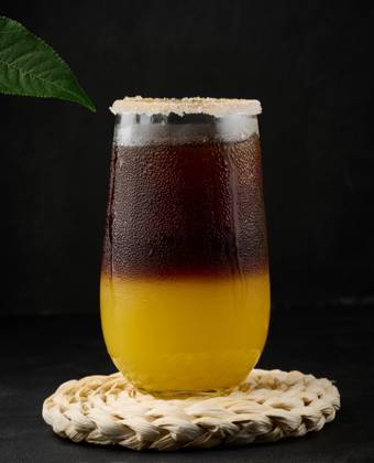 Iced coffee with orange juice in a transparent glass, refreshing bumble coffee on the table, black background Copyright: xDANKOxN RECORD DATE NOT STATED