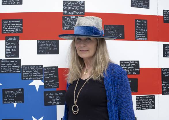 May 19, 2024, Washington, District Of Columbia, USA: Acclaimed visual artist Suzanne Brennan Firstenberg poses for a photograph with her art installation alienable right to life, at Freedom Plaza in Washington, D.C. The installation features a massive American flag created from the names of 1,039 mass shooting victims overlaying an image of the Declaration of Independence. Additional elements are an original poem addressing all victims of gun violence, and a circular mural for visitors to share personal stories. Washington USA - ZUMAr125 20240519_fap_r125_005 Copyright: xProbalxRashidx