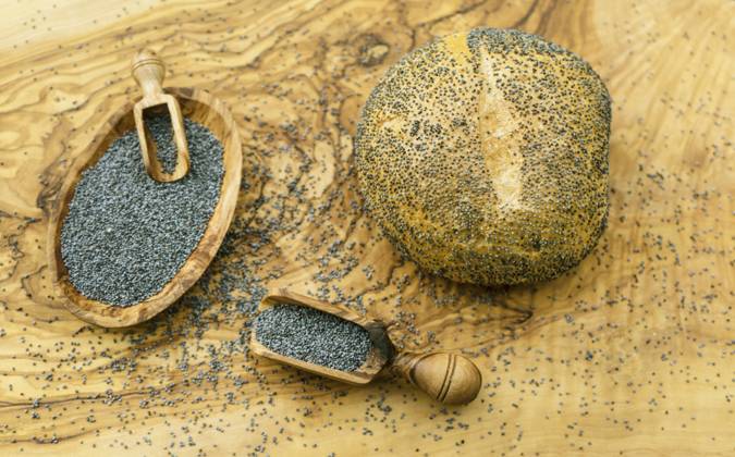 Rolls and Poppy seed in Wooden bowl and at Holzschaeufelchen Poppy Seed Rolls and Poppy Seeds in a Wooden Bowl and ON a Wooden Scoop BLWS709976 Copyright: xblickwinkel Steidix