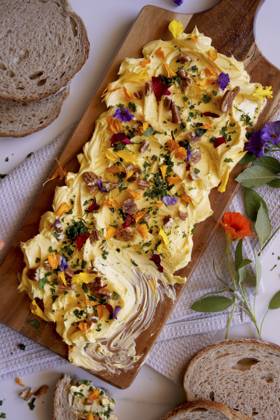 Herb, pecan and edible flowers butter board close up. Herb, pecan and edible flowers butter board close up. Copyright: xMilleflorexImagesx MIL190224-15