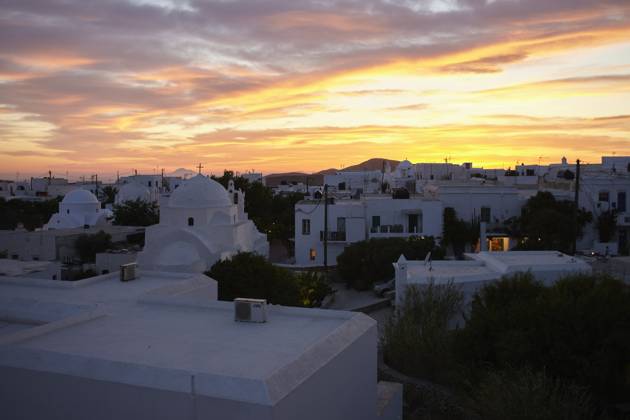 Sunset over a serene town with buildings displaying the iconic whitewashed architecture under a dramatic sky. Folegandros Greece bola01013 Copyright: xConnectxImagesx