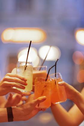 Close-up of female and male hands holding glasses of lemonade. Men and women clink cups. Carbonated drinks with ice cubes and straws. Close-up of female and male hands holding glasses of lemonade. Men and women clink cups. Carbonated drinks with ice cubes and straws. A party or a meeting of friends. Copyright: xZoonar.com DashaxPetrenkox 21776011