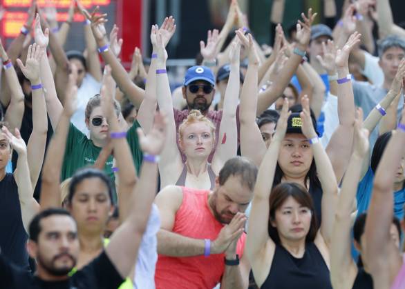 People attend a yoga class in celebration of the summer solstice at an 22nd annual all-day outdoor yoga event in Times Square in New York City on Thursday, June 20, 2024.  NYP20240620112 JohnxAngelillo